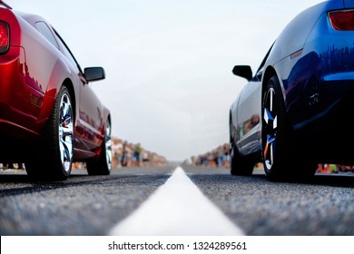 cars at the start, competitions, powerful cars, unlim 500, dragracing, red and blue auto at the start, a crowd of fans, muscle cars ready for dragrace,street car racers - Shutterstock ID 1324289561