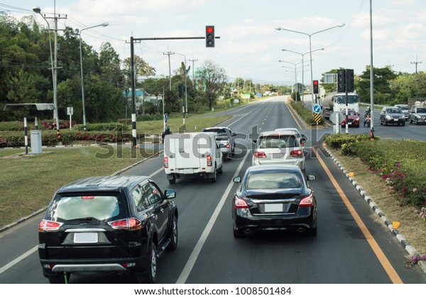 Cars stop red traffic light at the intersection\
of the Asian Highway