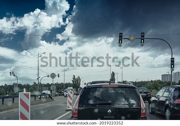 Cars\
are stuck on road in bad rainy weather. Thundercloud over highway.\
travel by car in bad weather. Ukraine Kiev 08\
2021