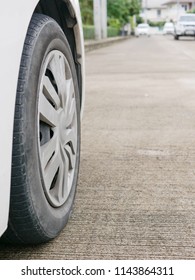 Car's Tire On Concrete Road With Proper Tire Pressure Being Ready For A Safe Driving Off