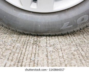 Car's Tire On Concrete Road With Proper Tire Pressure Being Ready For A Safe Driving Off