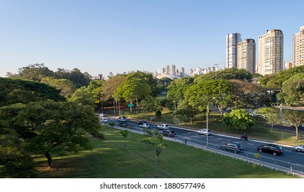 Cars traffic avenue in Sao Paulo city  near to Ibirapuera Park, a very wooded region with a lot of nature preservation. - Shutterstock ID 1880577496