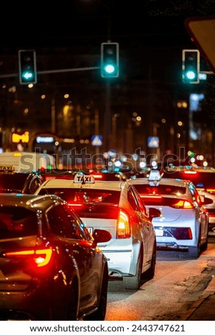 Cars in a traffic jam in the center of a big city at night.
