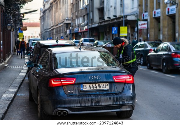 Cars in traffic at rush\
hour in downtown area of the city. Car pollution, traffic jam in\
the morning and evening in the capital city of Bucharest, Romania,\
2021