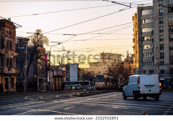 Cars in traffic at rush\
hour in downtown area of the city. Car pollution, traffic jam in\
the morning and evening in the capital city of Bucharest, Romania,\
2021