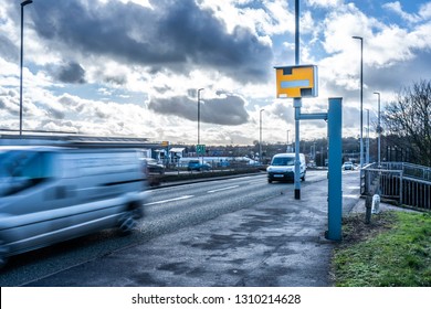 Cars travel past a speed camera in Stoke on Trent, slowing down as they pass the camera, safe driving