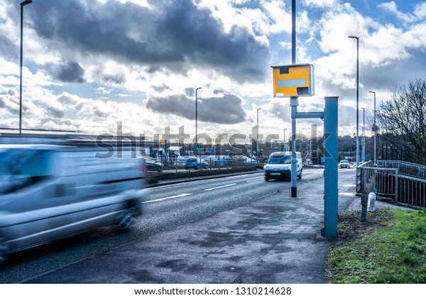 Cars travel past a speed\
camera in Stoke on Trent, slowing down as they pass the camera,\
safe driving