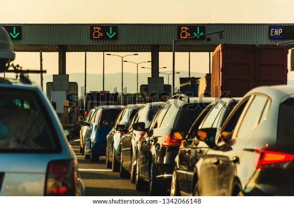 Cars and trucks\
waiting at point of toll highway - Toll station check point traffic\
jam - Highway toll peage