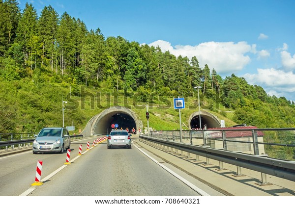 cars at tunnel entrance / exit on highway,\
german autobahn