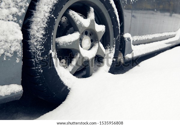 Cars tyre\
covered by snow on street in winter\
day