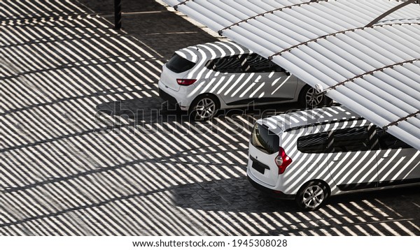 Cars under the shadow\
from the canopy