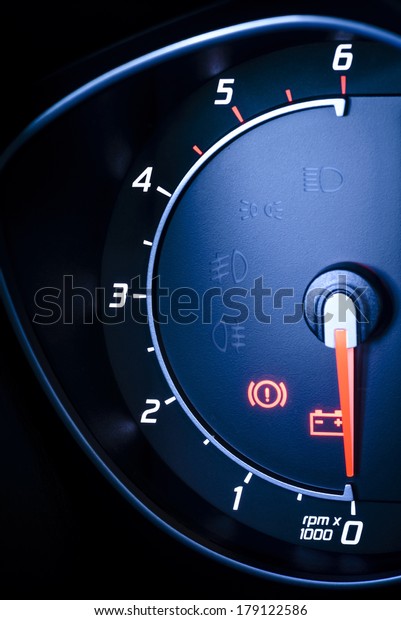 Car\'s, vehicle\'s speedometer or tachometer\
with visible information display - ignition and brake system\
warning lamp, visible symbols of instrument cluster, with warning\
lamps illuminated.