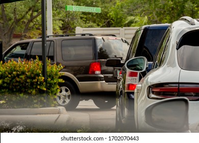 Cars waiting in a drive thru lane. Sports utility vehicles in America. 