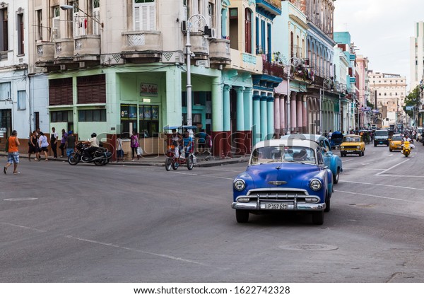 Cars, walkers &\
cyclists captured early one evening in Centro Havana in Cuba during\
November 2015.