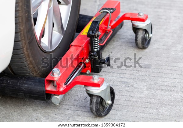 Cars wheel locked at parking line,\
concept of traffic violation rules, selective\
focus