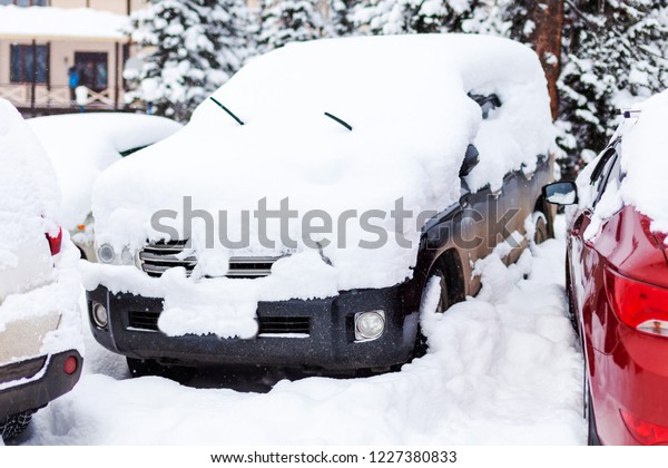 cars in winter\
heavily covered with snow
