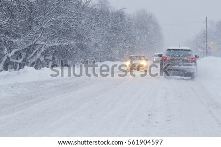 Cars with winter tires on snow-covered road