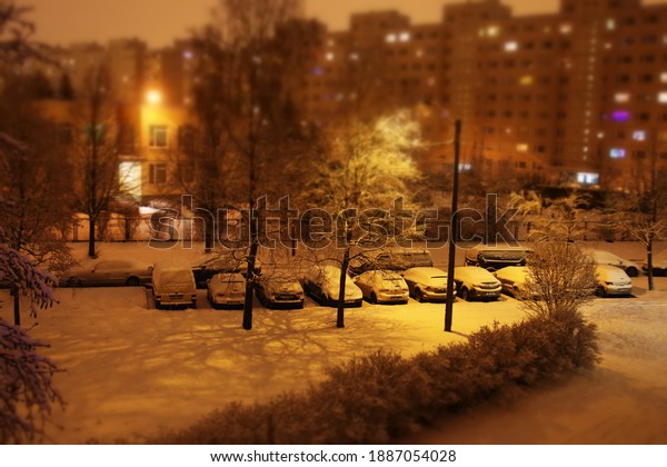 cars in the yard covered\
with snow