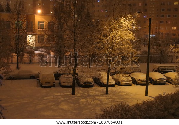 cars in the yard covered\
with snow