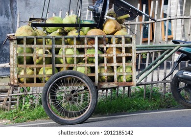 A cart filled with young coconuts ready for sale