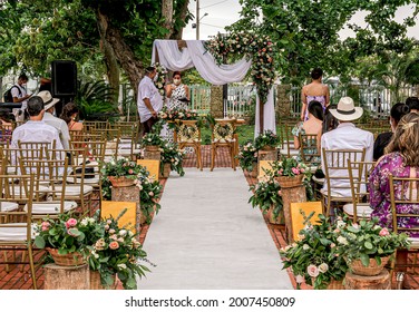 Cartagena, Bolivar, Colombia; 06-19-2021: Outdoor Wedding Altar With A White Carpet, Flowers And Guests.