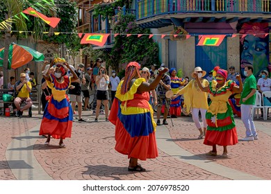 Cartagena, Bolivar, Colombia; 11- 11- 2021: Native Women Of San Basilio De Palenque With Their Brightly Colored Dresses Dance In The Plaza. 