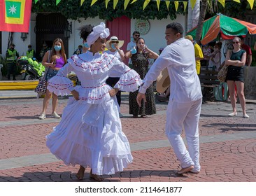 Cartagena, Bolívar, Colombia; 11- 11- 2021: Enthusiastic couple dressed in white dance a Colombian cumbia, traditional rhythm which have contribution of three cultures.