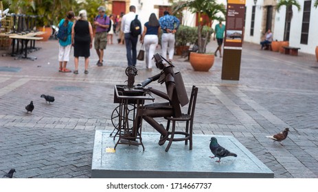 Cartagena, Colombia - March 15th 2020: Statue Of A Man Sewing Face Masks For Pandemic Crisis.