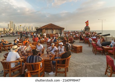 Cartagena, Colombia - May 11 2022: Tourists And Local People Enjoy A Drink At The Famous Café Del Mar On The Fortification Of Cartagena Colonial Old Town By The Caribbean Sea In Colombia At Sunset