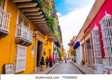 CARTAGENA, COLOMBIA- October  22, 2017: Unidentified people walking in Cartagena city street with colorful buildings of Cartagena Walled City