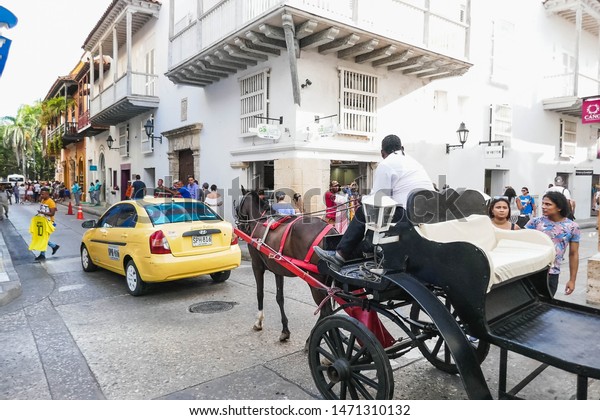 Cartagena de Indias / Colombia - 08/05/2019:\
Horse pulling the tourist car through the busy streets of the city.\
Cocept means of\
transport