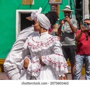 Cartagena de Indias; Colombia; 11  11 2021: Woman dancing with typical dress in the Independence day of Cartagena celebration on the La Trinidad Square of Getsemani neighborhood at the morning