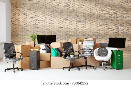 Carton boxes with stuff in empty room. Office move concept - Shutterstock ID 750842272