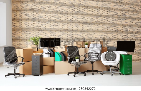 Carton boxes with stuff in empty room. Office\
move concept