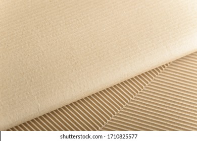 Carton Or Cardboard Packing Material. Texture Of Corrugated Paper Sheets Made From Cellulose. Supplies For Creating Boxes And Packaging. Pasteboard Background. Natural Brown Cardboard Surface.