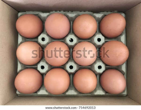 A carton egg in
a box with a dozen of eggs