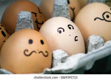 Carton of eggs with drawn-on faces