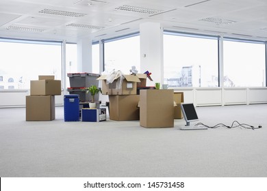 Cartons and equipment on floor of empty office space - Shutterstock ID 145731458