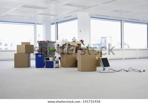 Cartons and\
equipment on floor of empty office\
space