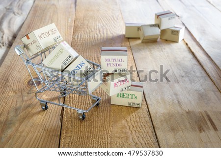 Cartons of financial investment products in a trolley i.e stocks, bonds, commodities, funds, REITs, ETFs. A concept of wealth management by diversifying assets to minimize risk and gain more profits.