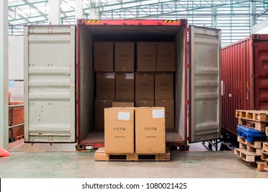 The cartons with loading out of container - Shutterstock ID 1080021425