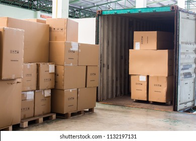 The cartons with loading out of container - Shutterstock ID 1132197131