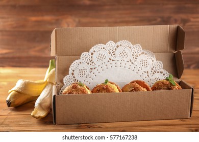 Cartoon Box With Delicious Lemon Ice Cream Cookie Sandwiches On Wooden Table, Closeup