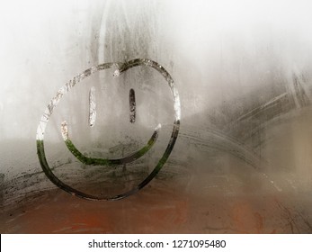 Cartoon Happy Smiley Face Drawn On A Condensation Covered Window During The Day