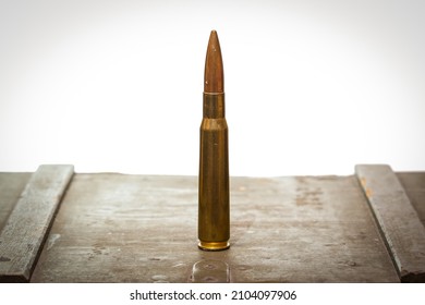 Cartridge 50 caliber 12.7mm on a white background close-up.
