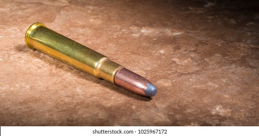 Cartridge that was used in 303 chambered rifles on a beige background