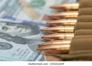 Cartridges With Bullets In A Bandolier, Dollar Bills. Close-up. Concept: Sale Of Weapons Under Lend-lease, Military Special Operation, Mercenary Activity In The Army, The War In Ukraine.