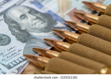 Cartridges with bullets in a bandolier, dollar bills. close-up, selective focusing. Concept: sale of weapons under lend-lease, assistance with weapons, mercenary work in the army, the war in Ukraine.