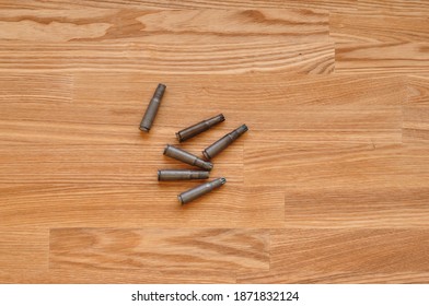 Cartridges of dummy bullets on woody table