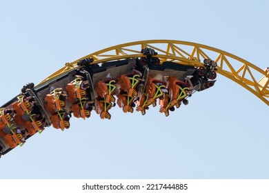 Carts with people perform a dead loop twisted into a spiral on roller coaster rails